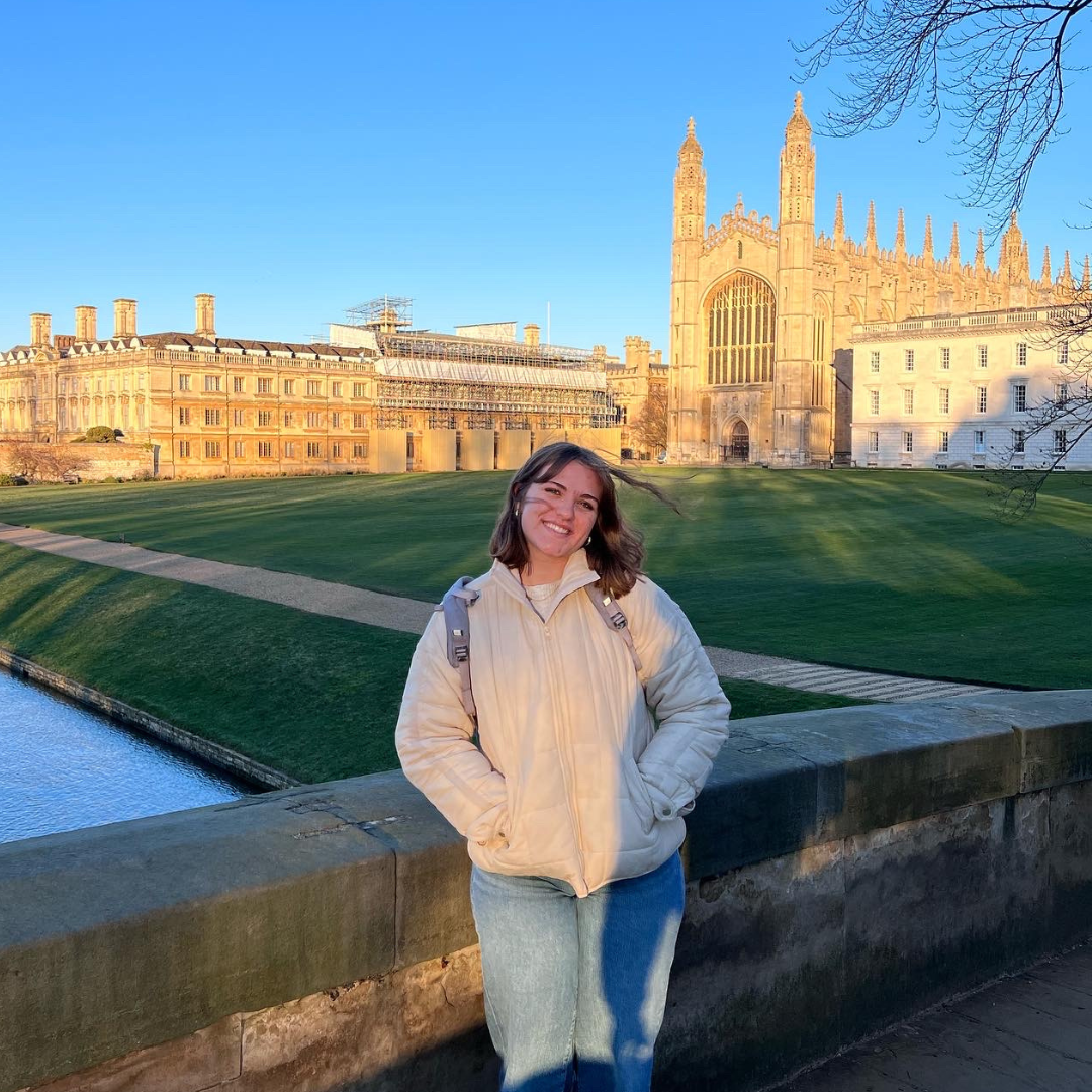 Student Gwen Butler poses in front of Cambridge Univeristy