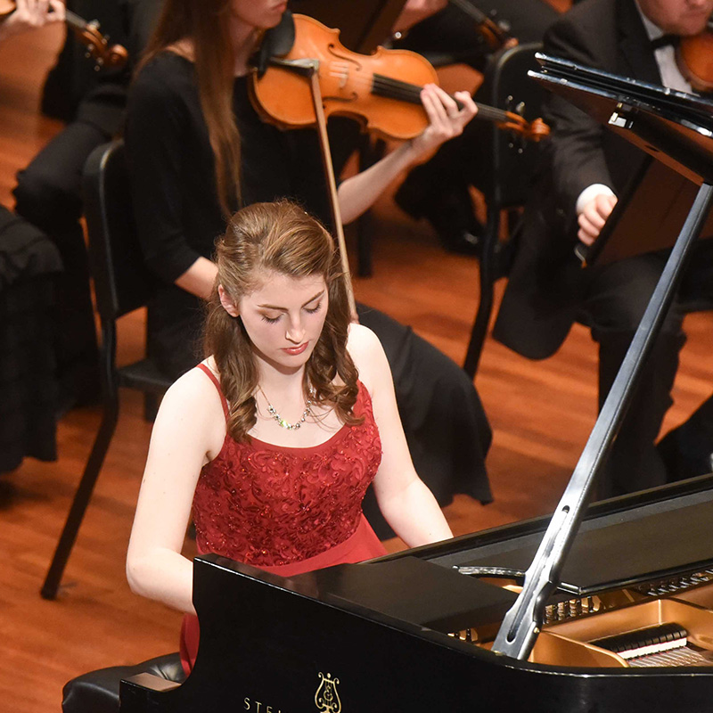 Piano student performing on stage