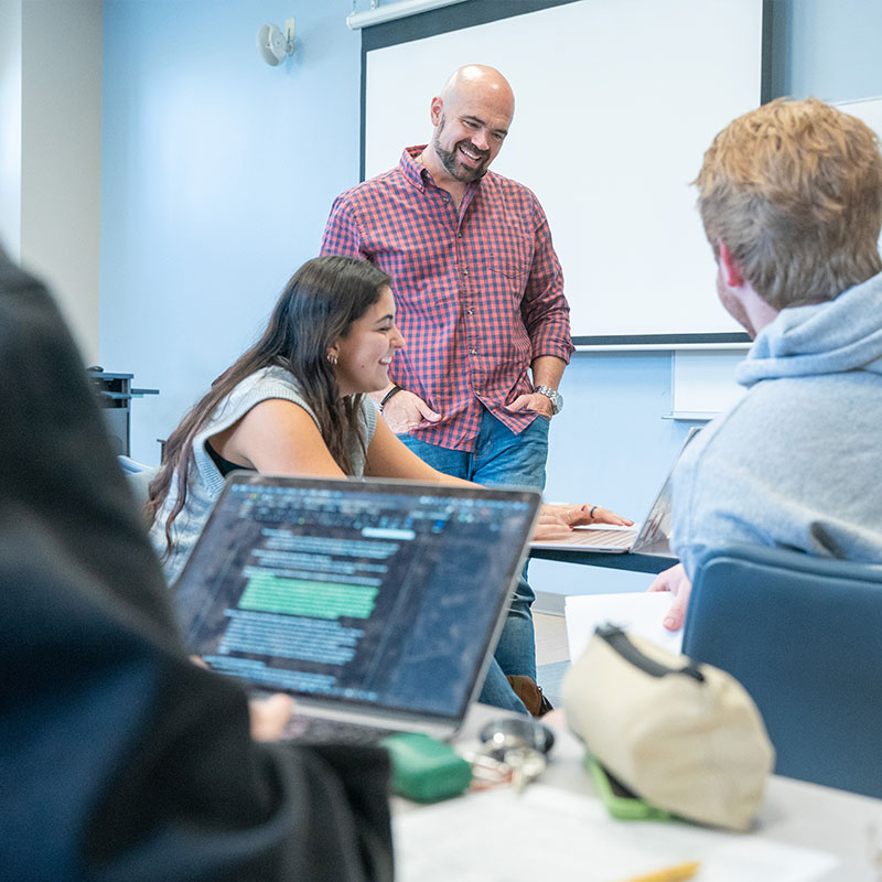 Professor laughing with a student during class