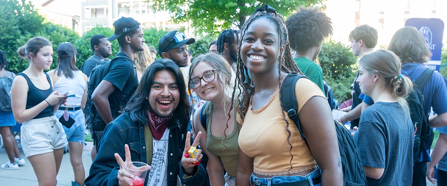 Groups of friends smile for the camera outside during Bruin Link Fair