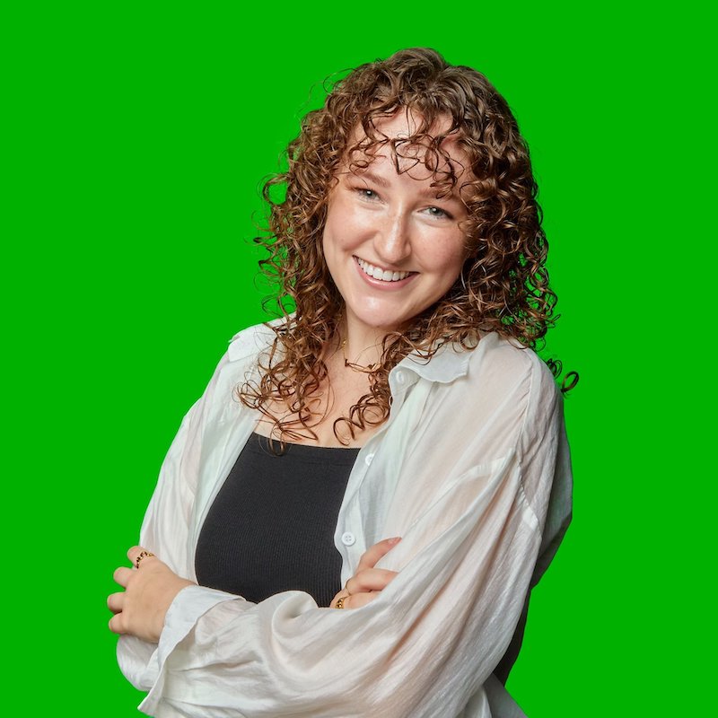 Photo of Claire Kelly in front of a bright green background