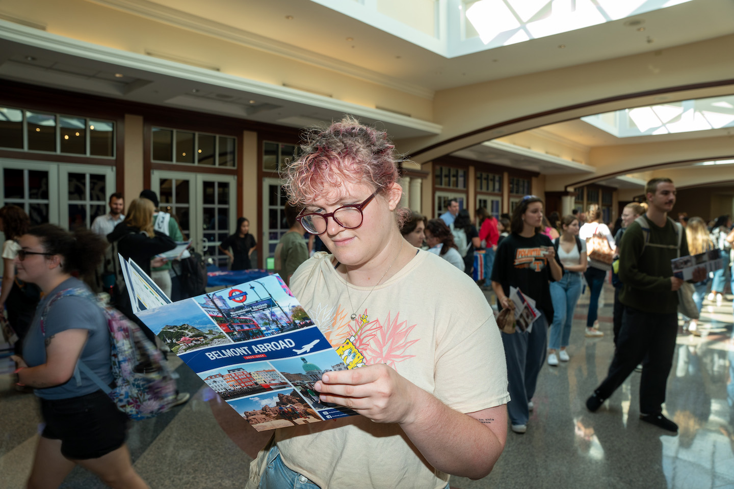 Student looks at a brochure at the 2023 Global Fair