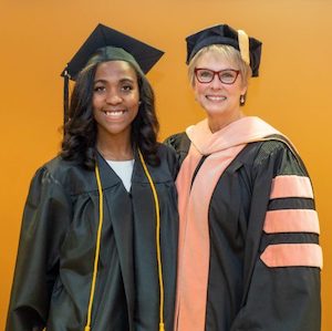 Shekinah McLaughlin and Dr. Cathy Taylor pose at Mclaughlin's graduation ceremony.