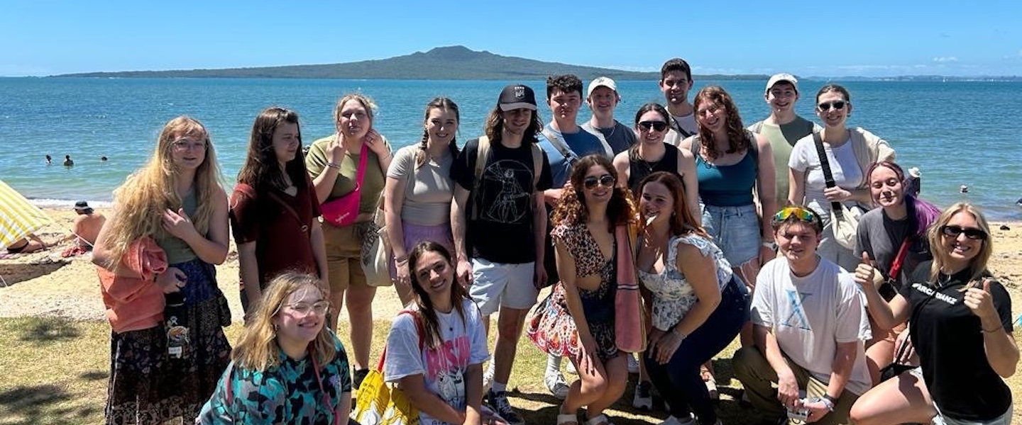 Claire Woodley with her Global Honors group on the picturesque shores of New Zealand.