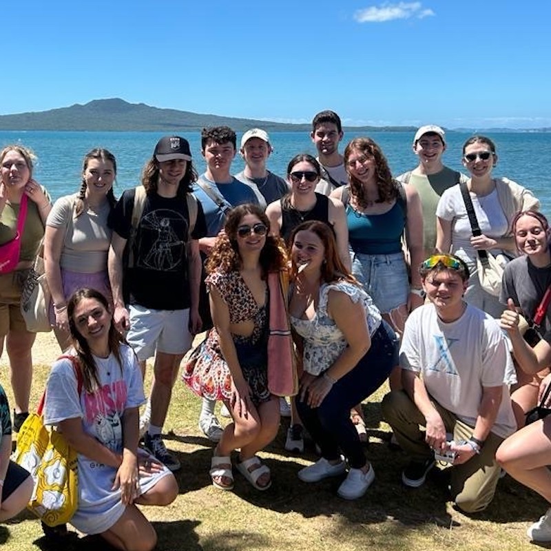 Claire Woodley with her Global Honors group on the picturesque shores of New Zealand.