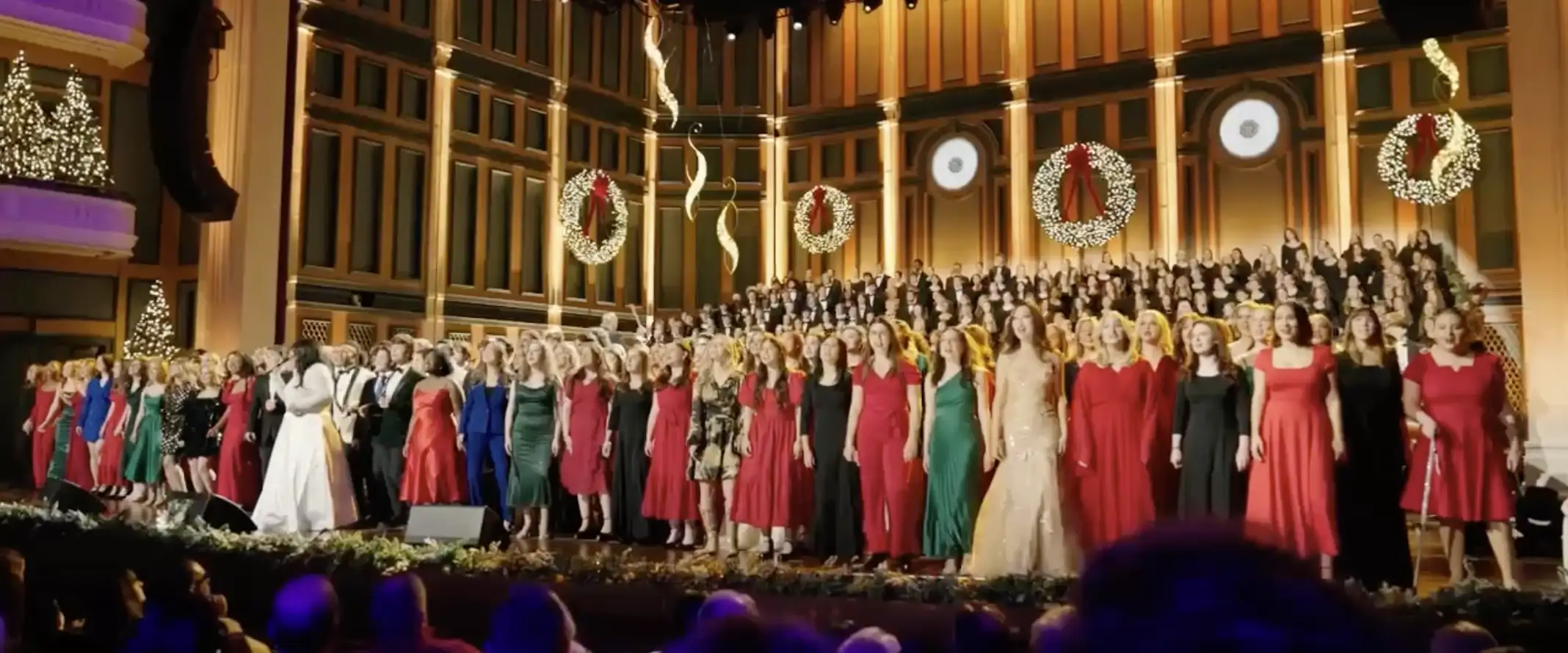Choir of students singing on stage at the Fisher center during Christmas at Belmont