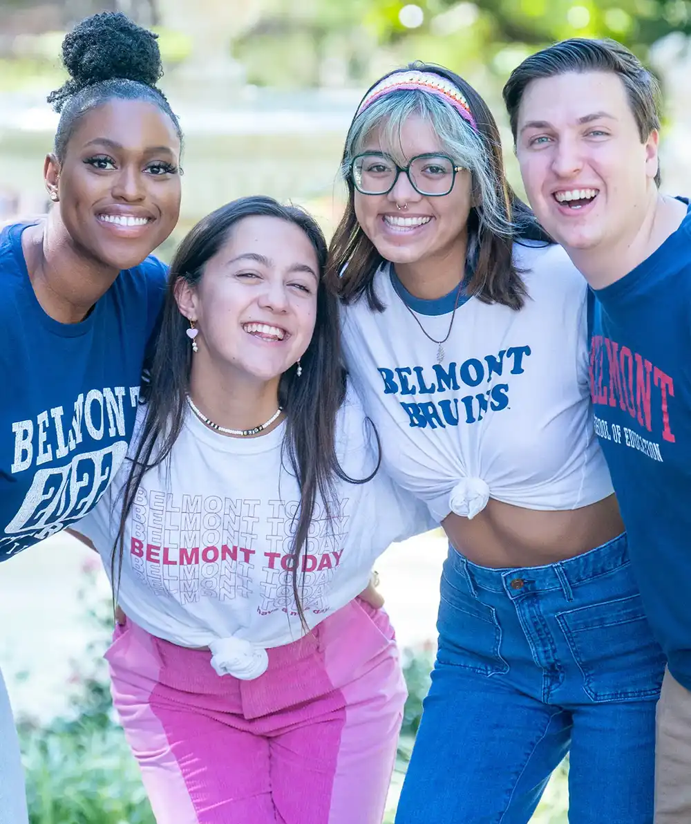 Four students pose together in an embrace