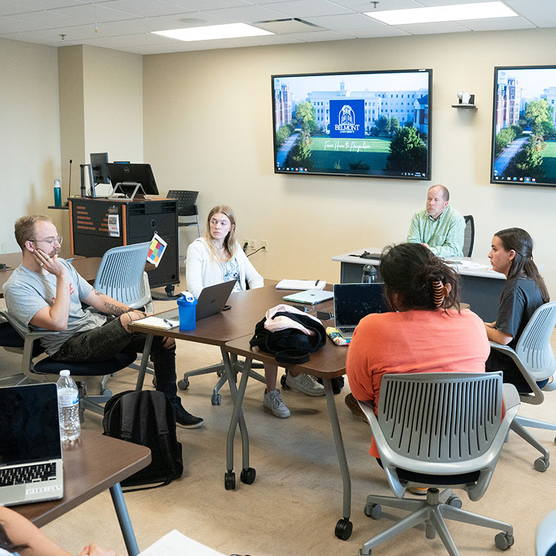 Massey students in a classroom talking with a professor