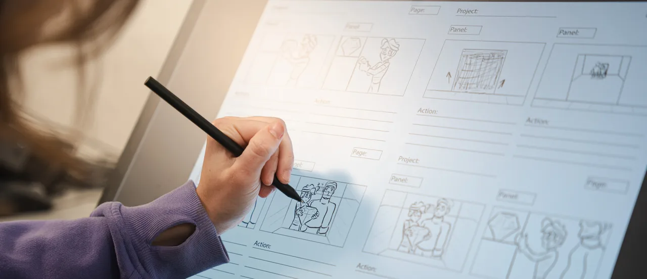 Designer sketching on a storyboard with marker, planning visual project scenes