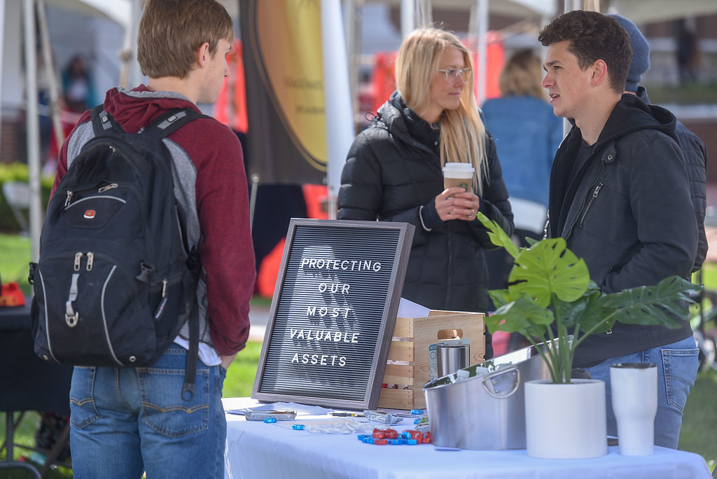 student hosts table at entrepreneurship fair