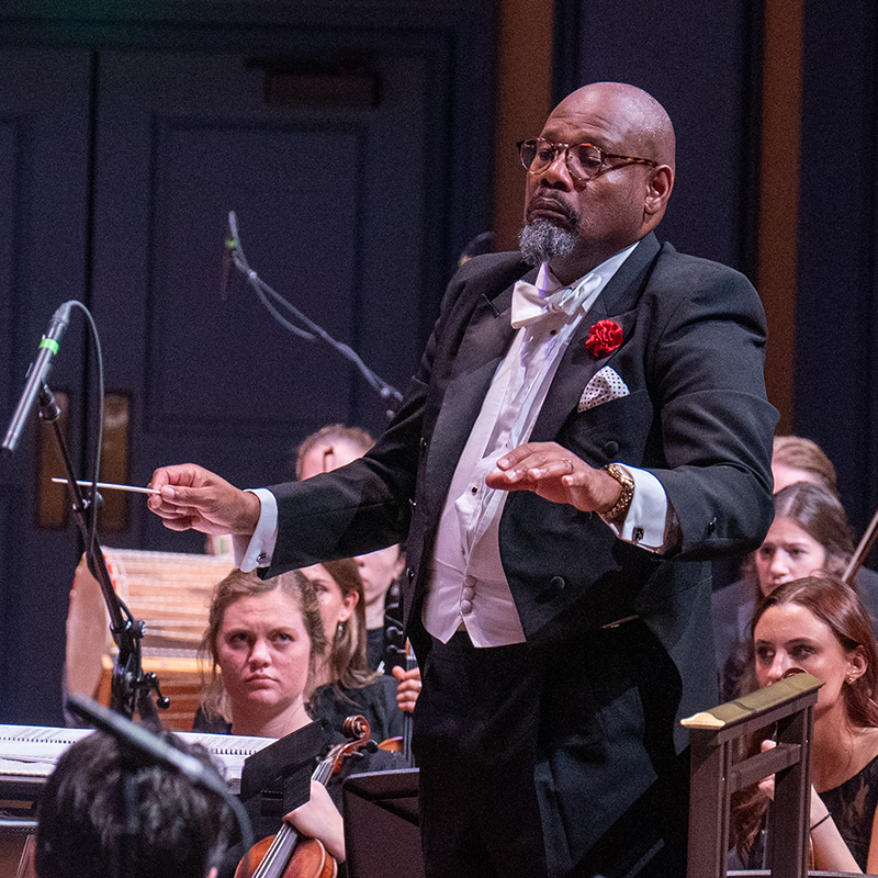 Conducting professor performing on stage