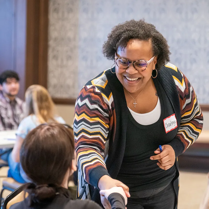 A social work student talking with a recruiter at a career fair