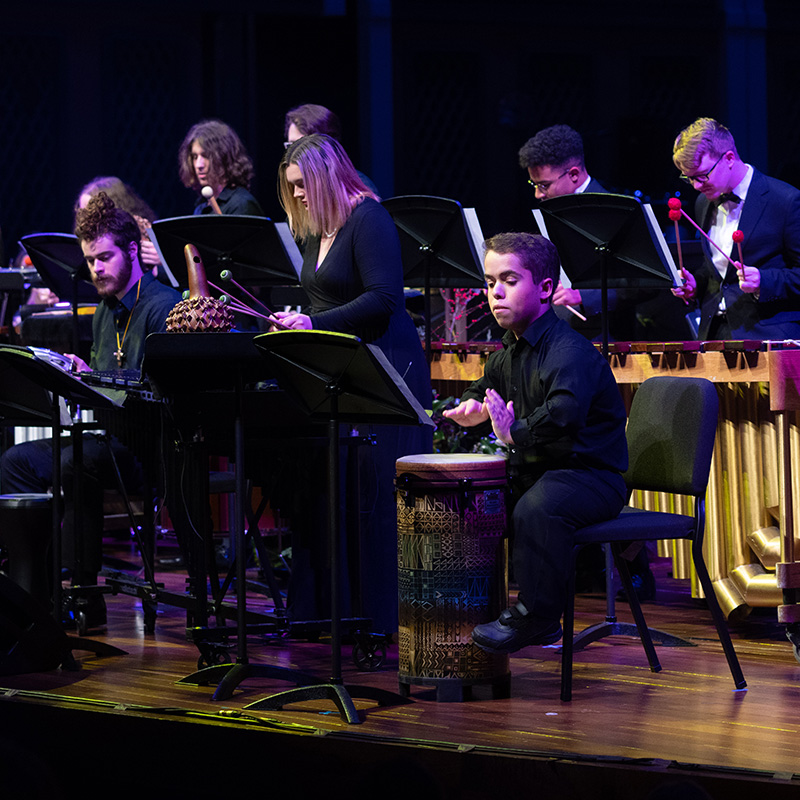 Music performance students performing on stage in the Fisher Center during Christmas at Belmont