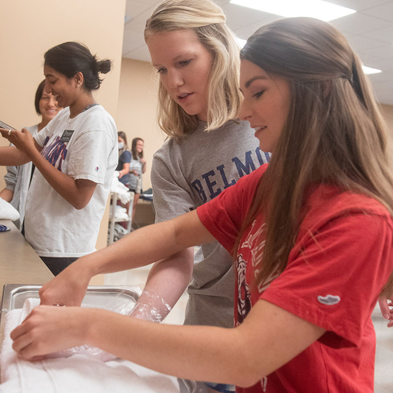 Two students working together at a counter in an OT Lab