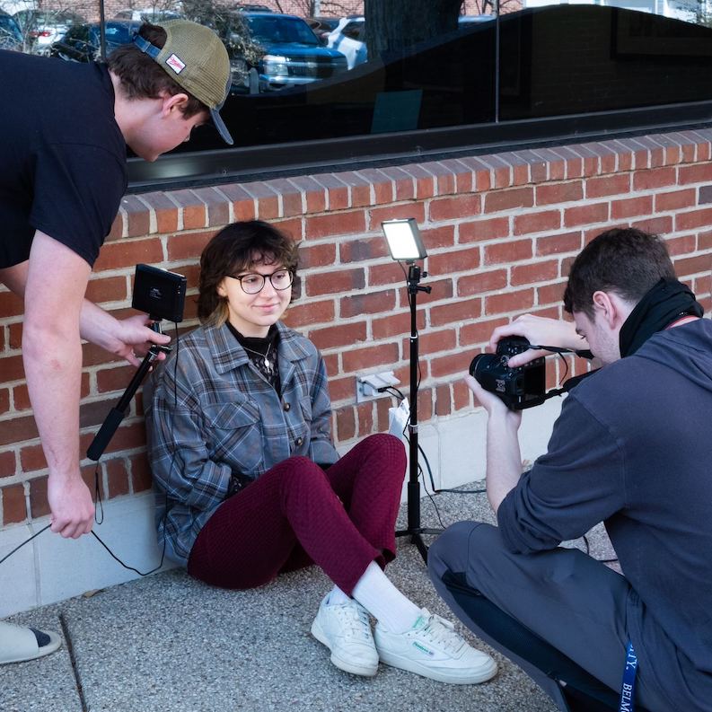 Students taking pictures of each other for class assignment