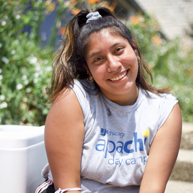 Photographic studies student Becca Pollak sits in front of plants