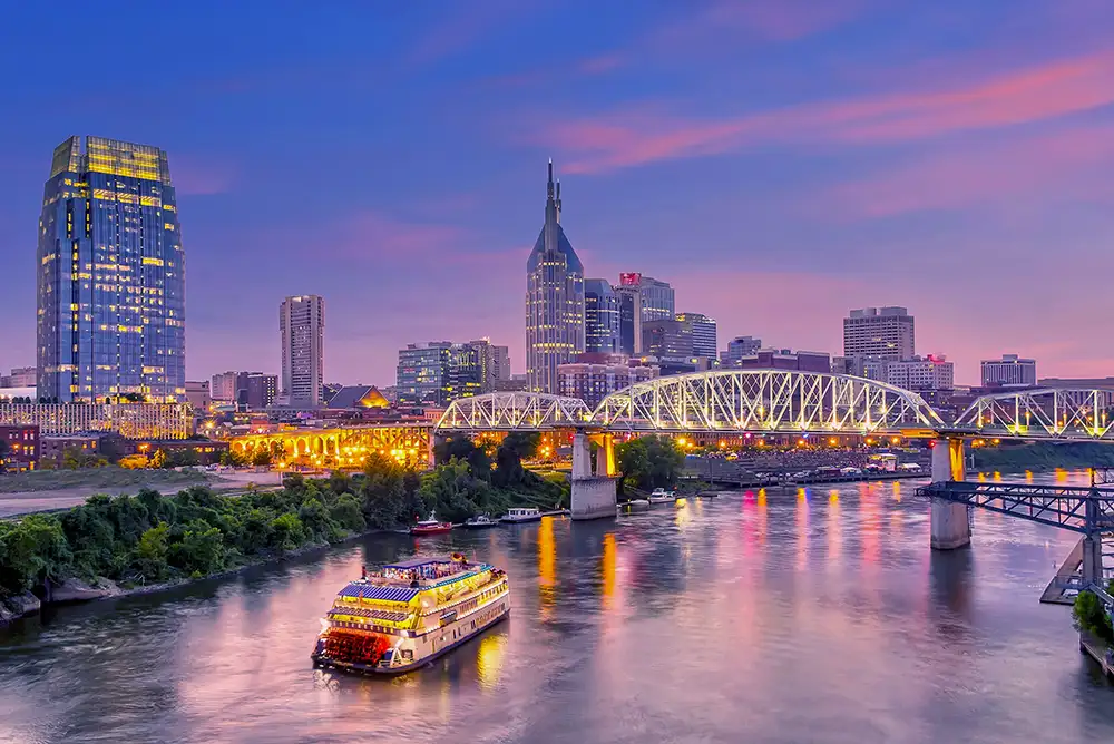 A view of downtown Nashville from across the Cumberland river with a tugboat in view