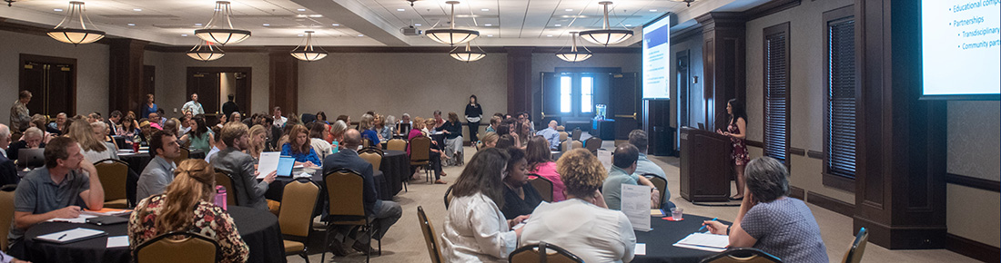 A conference room of people.