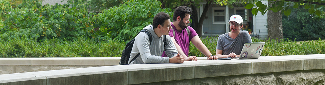 Students working on a computer outside on Belmont's campus