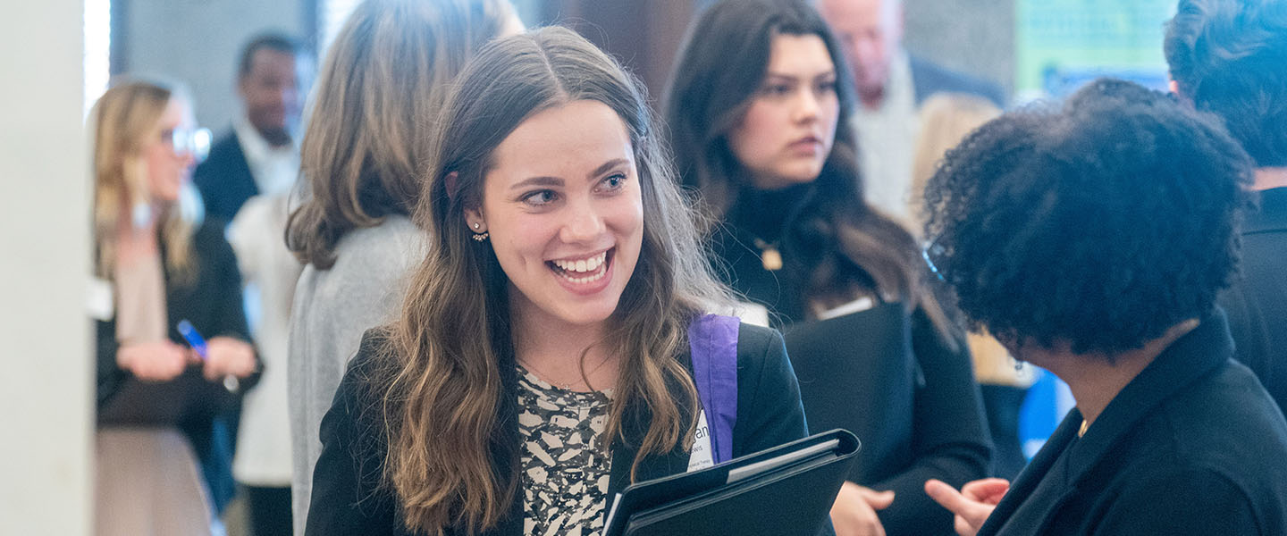 A student talking with an employer at a job fair