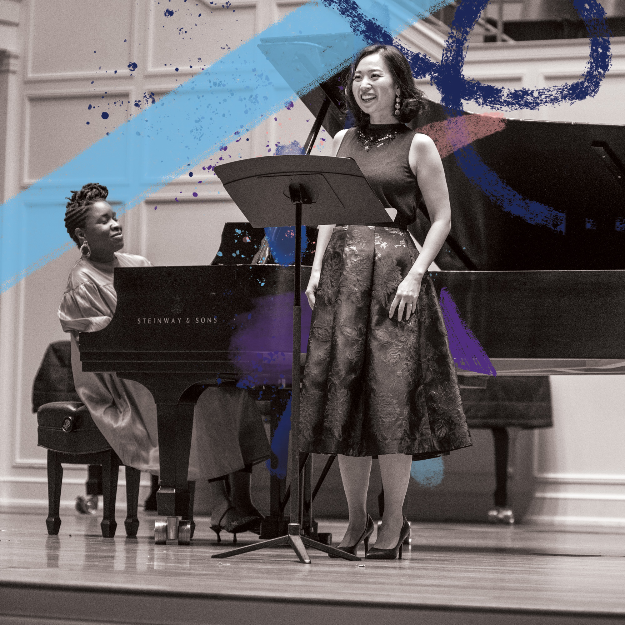 Grad student performing on stage with pianist in the background