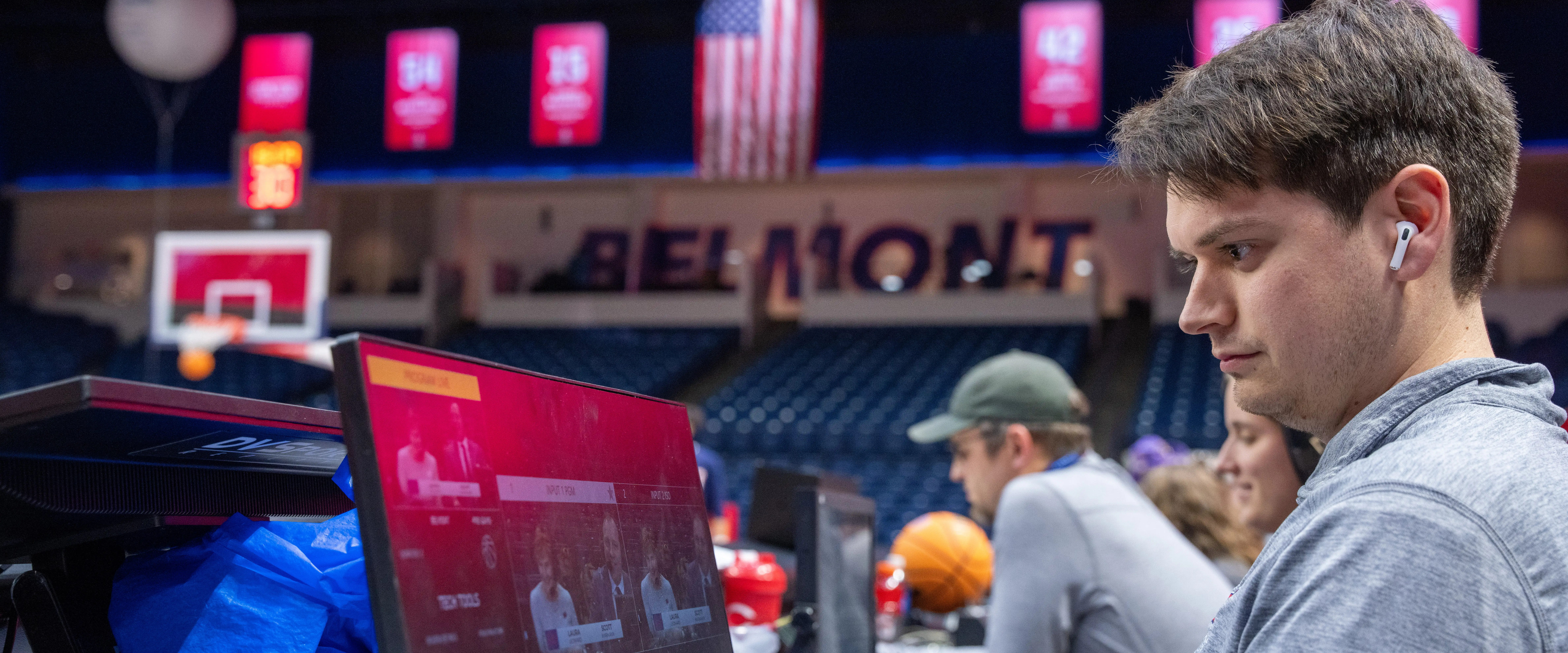 Student for Curb College working on a computer the Belmont Basketball game