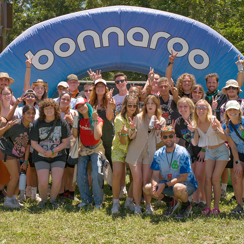 A group of students in front of a Bonnaroo Arch