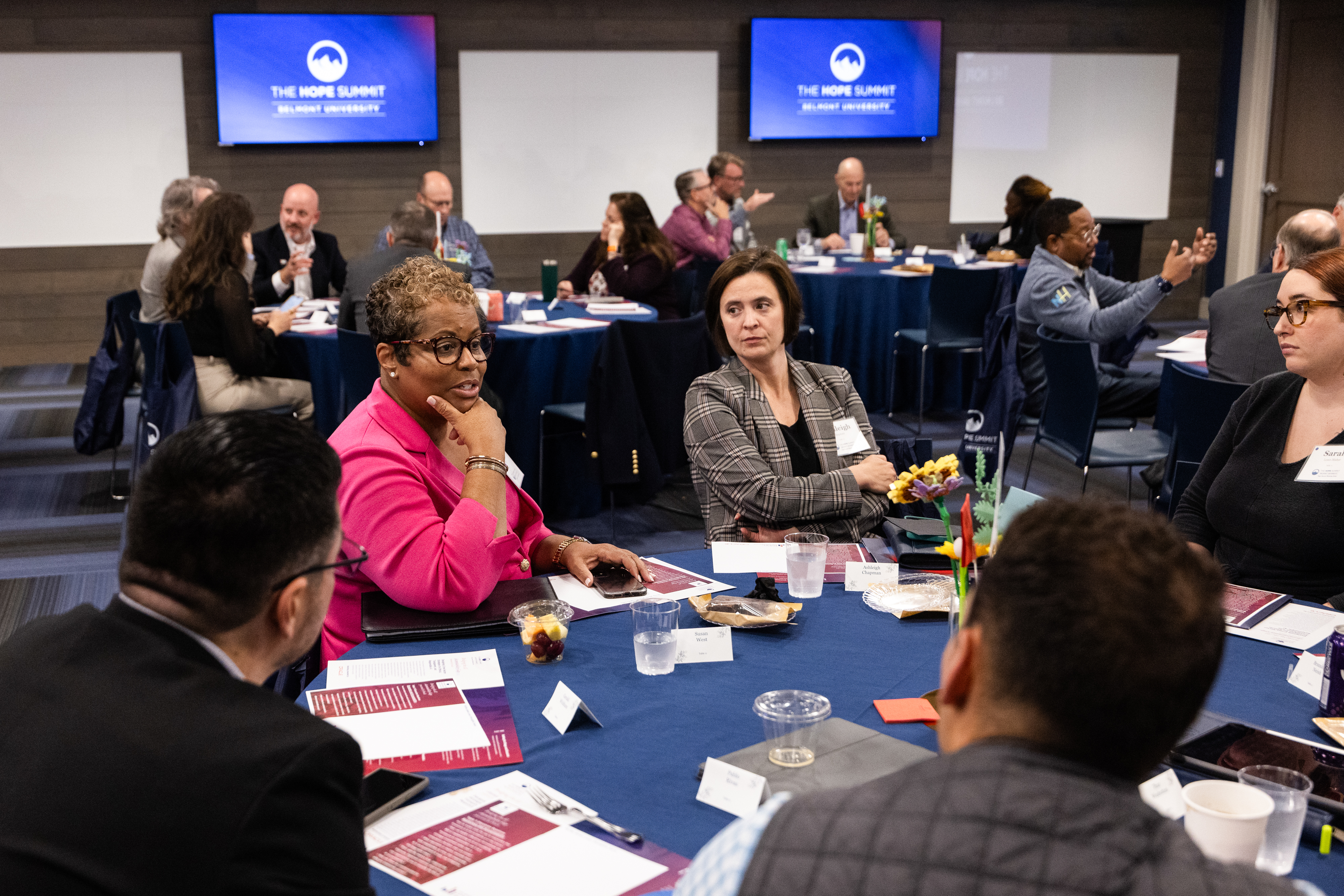 Nurses sitting at desk with laptops work together with the data collaboration team
