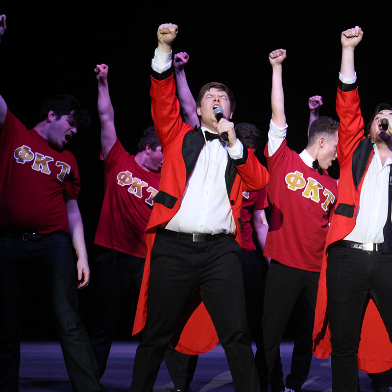 Phi Kappa Tau performing dramatically at Greek Sing