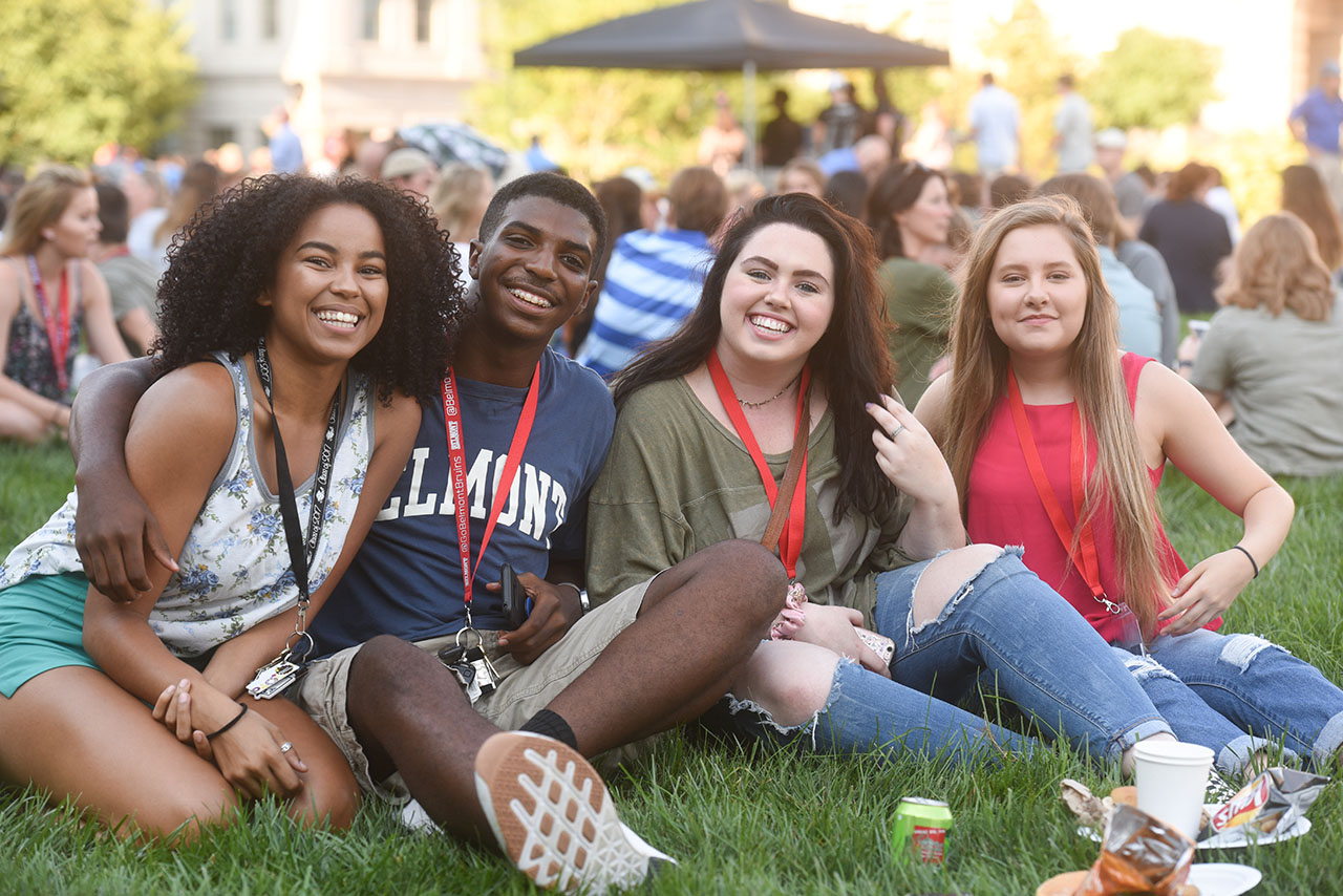Four first year students sit on Belmont's lawn during a Welcome Week event
