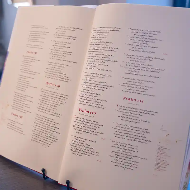 An open Bible displays passages from the Book of Psalms, including Psalms 139, 140 and 141.