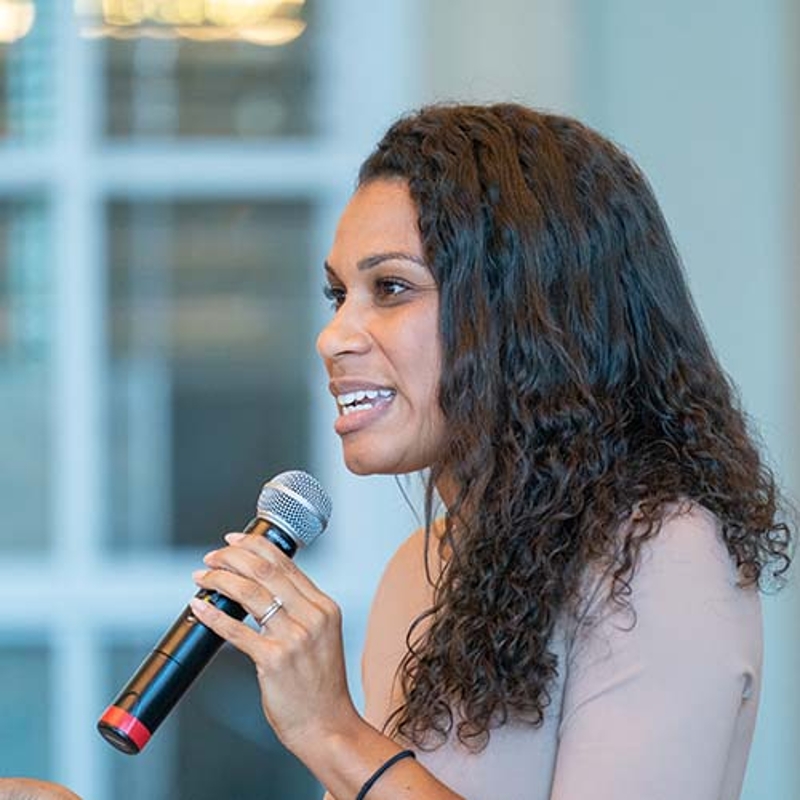 Speaker speaks into mic at seminar in the chapel