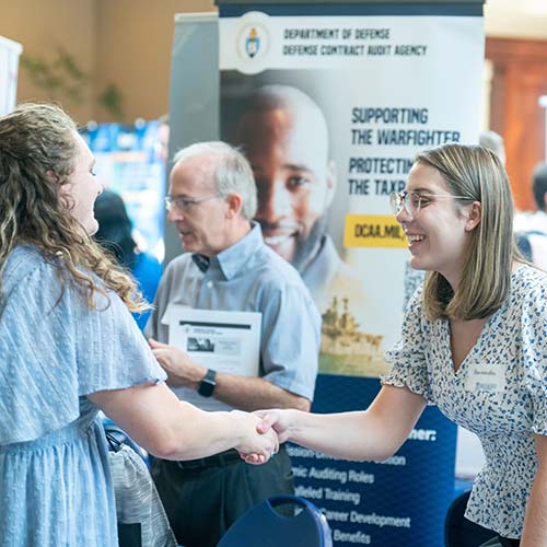 Students networking during student job fair on campus