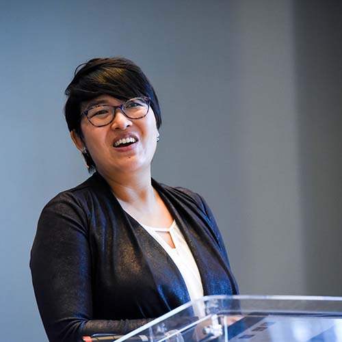 Female speaker speaks at podium