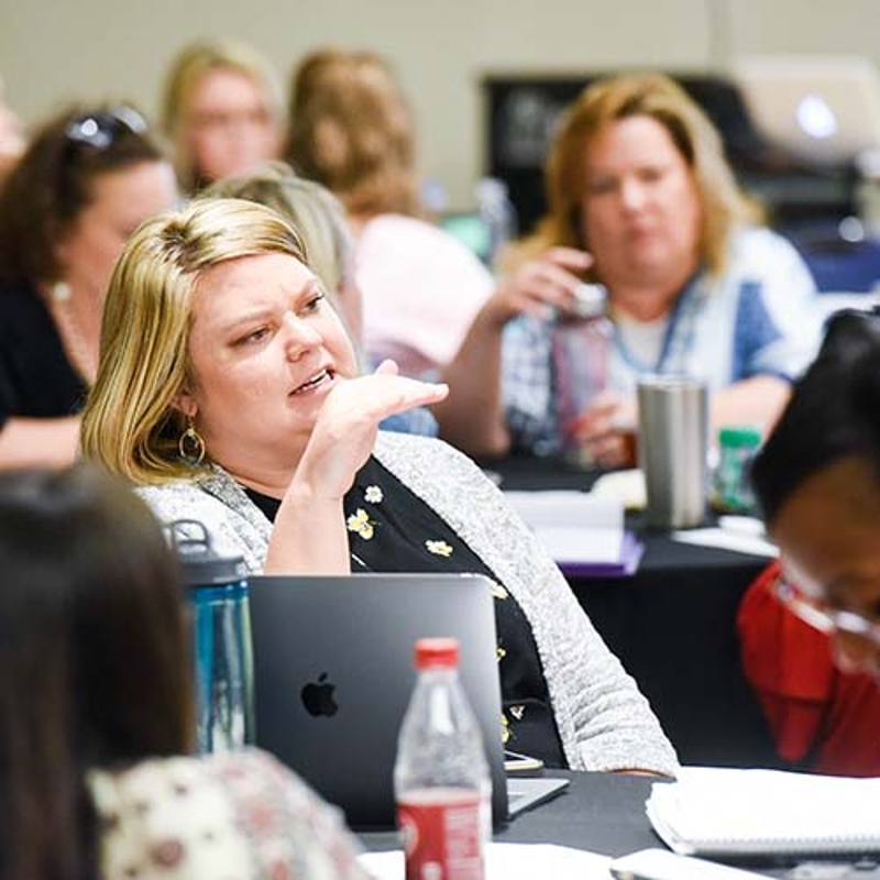 Student participates in class discussion with other students