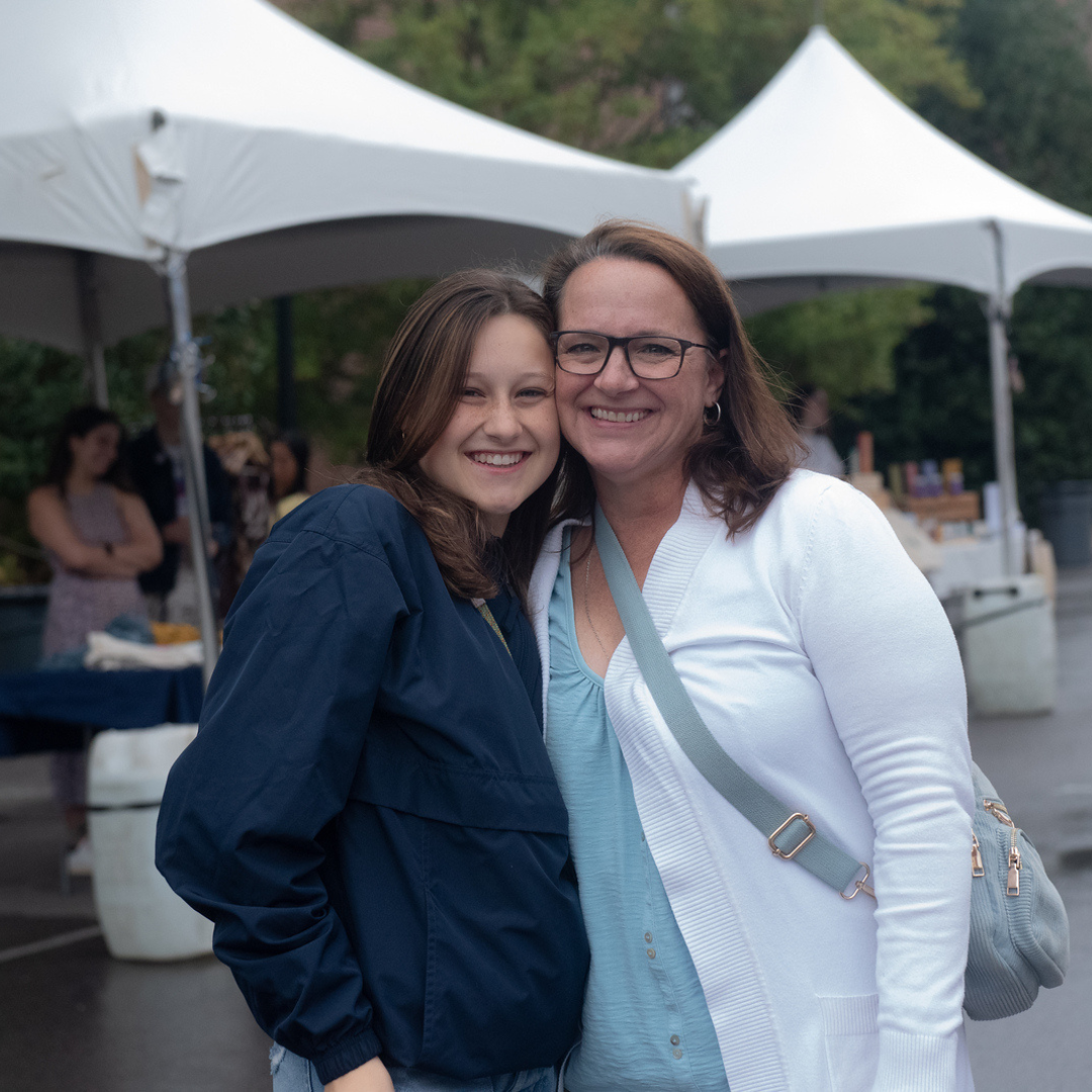 Associate Vice President for Engagement, Kate Mosley, smiles in conversation with a parent at a Parent Leadership Circle event.