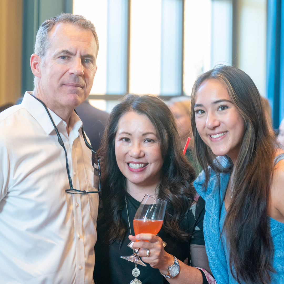 A mother, father and daughter smile for a picture at a Parent Leadership Circle event.