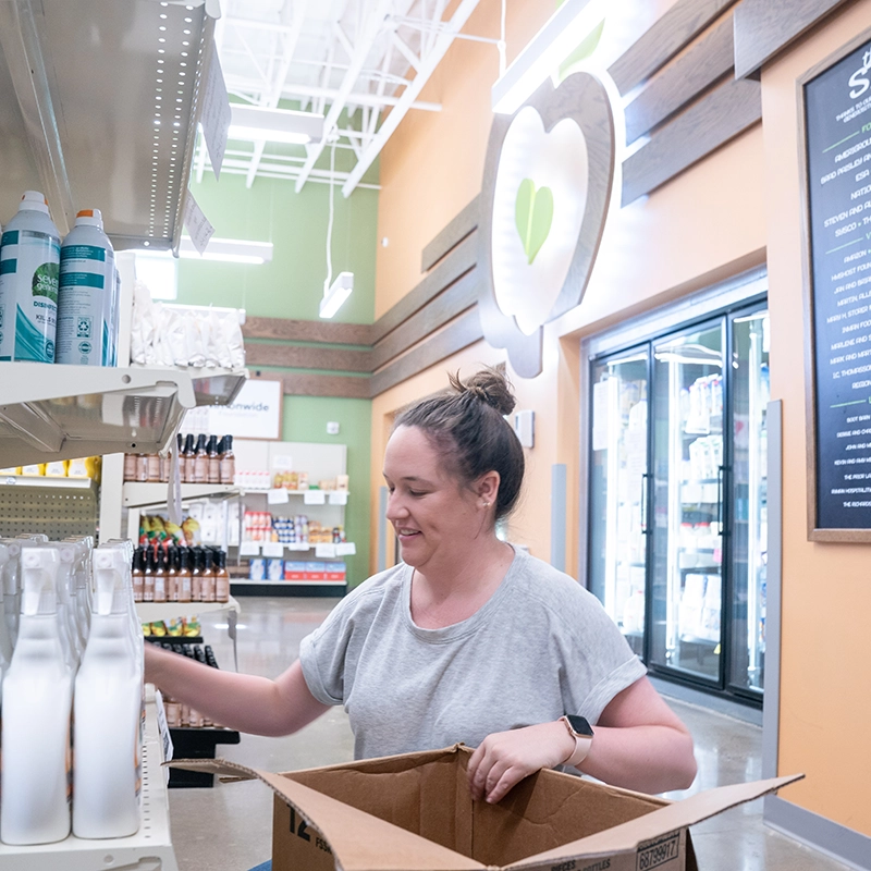 A team member stocking shelves at The Store