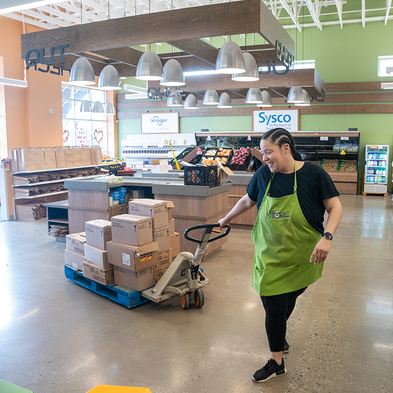 A worker at The Store pulling boxes into the store.