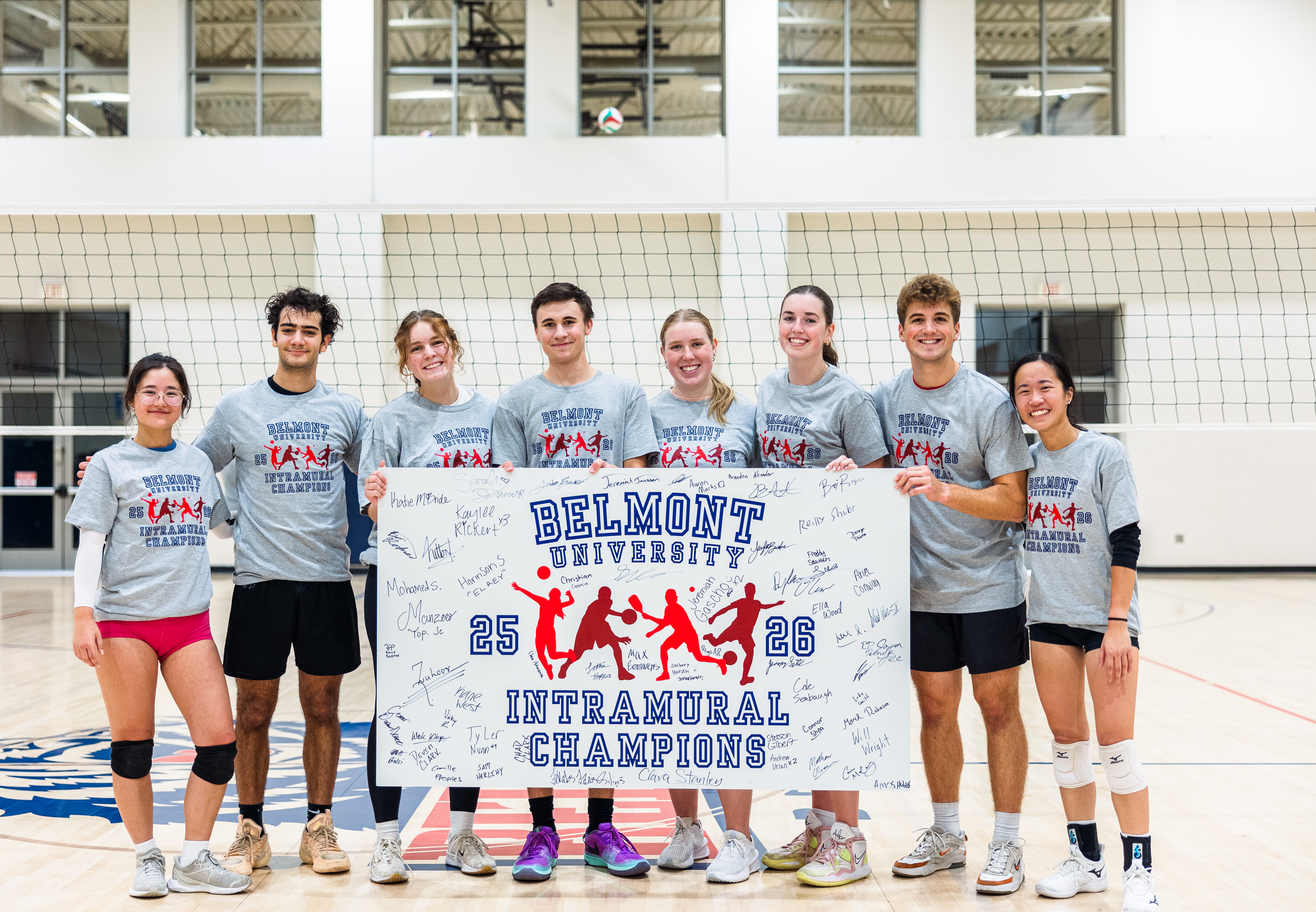 Students wearing Intramural Champion Shirt and posing with Champion Sign