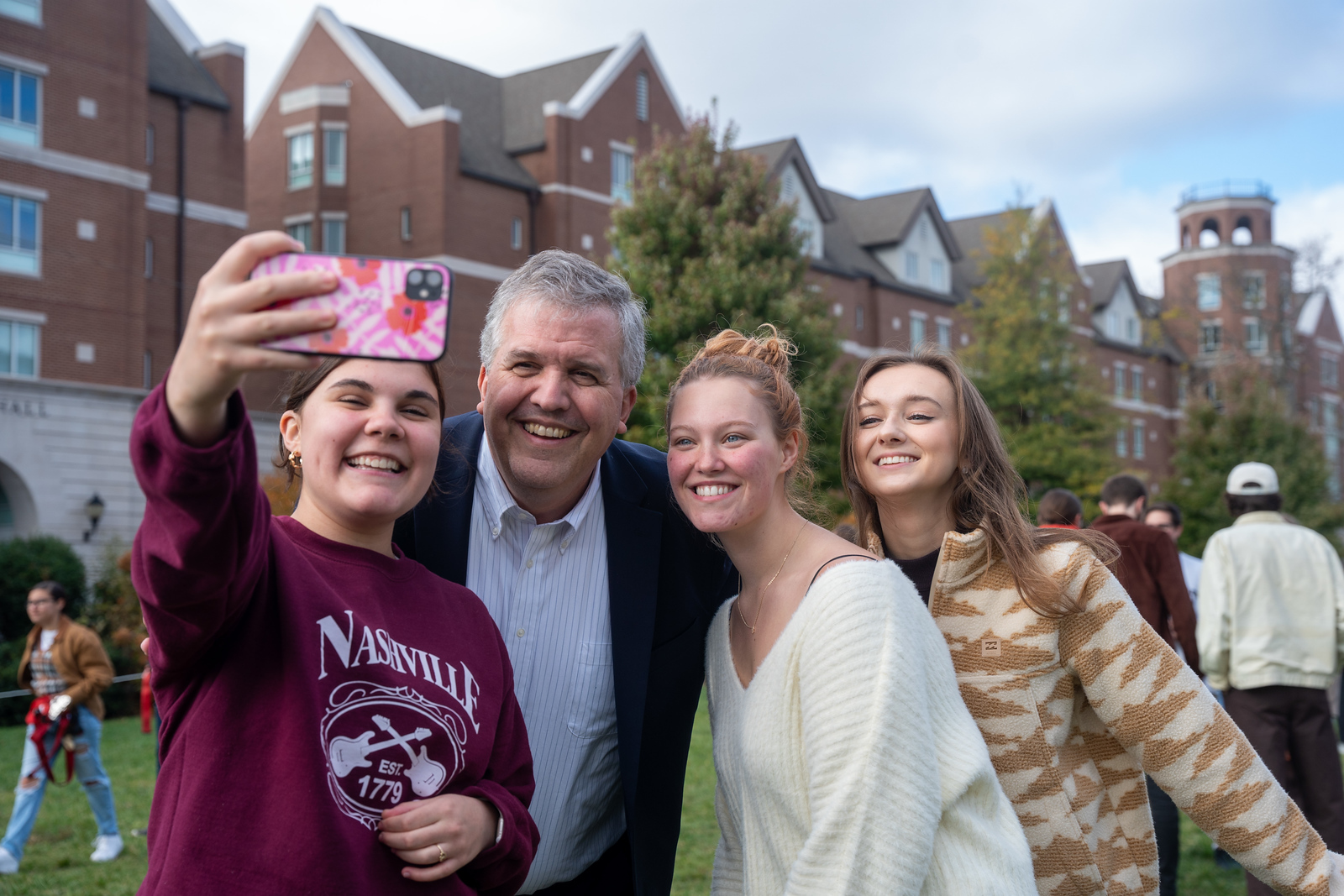 University president posing for a selfie with students