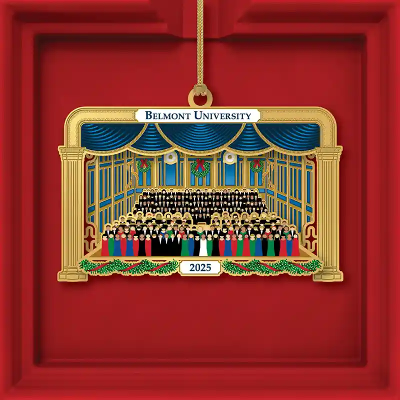 2025 Belmont University ornament depicting the Christmas at Belmont choir performing on a decorated stage with blue curtains.