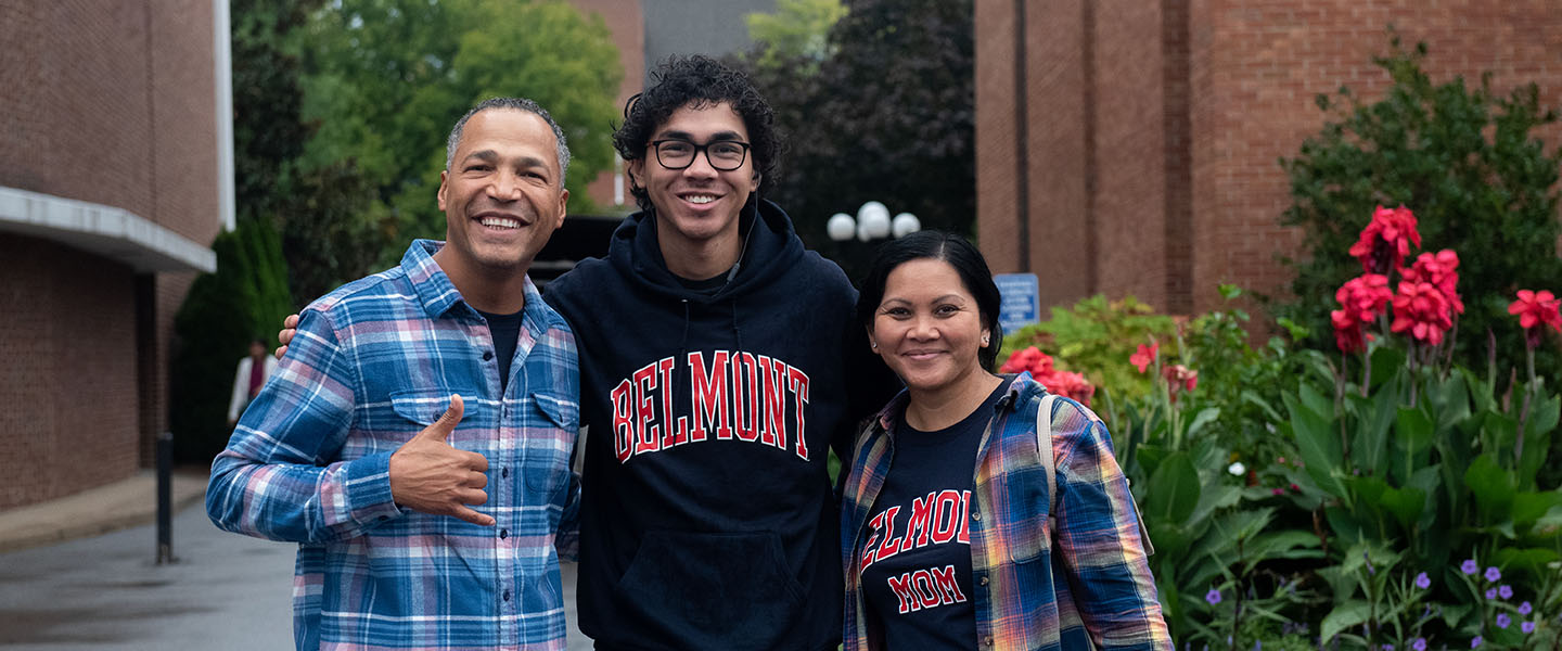 Two parents hug their son on the history side of campus
