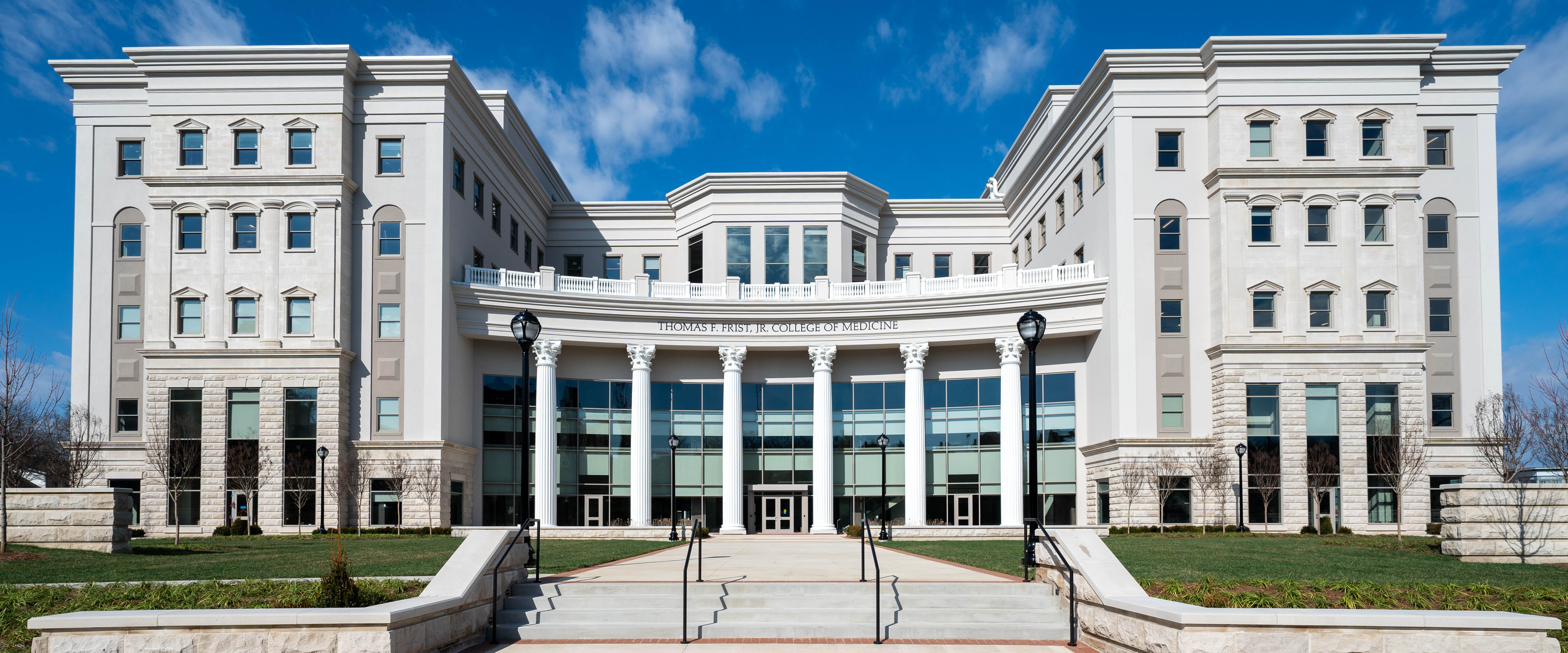 Frist College of Medicine exterior at Belmont University, featuring tall columns, large windows, and a blue sky in the background.