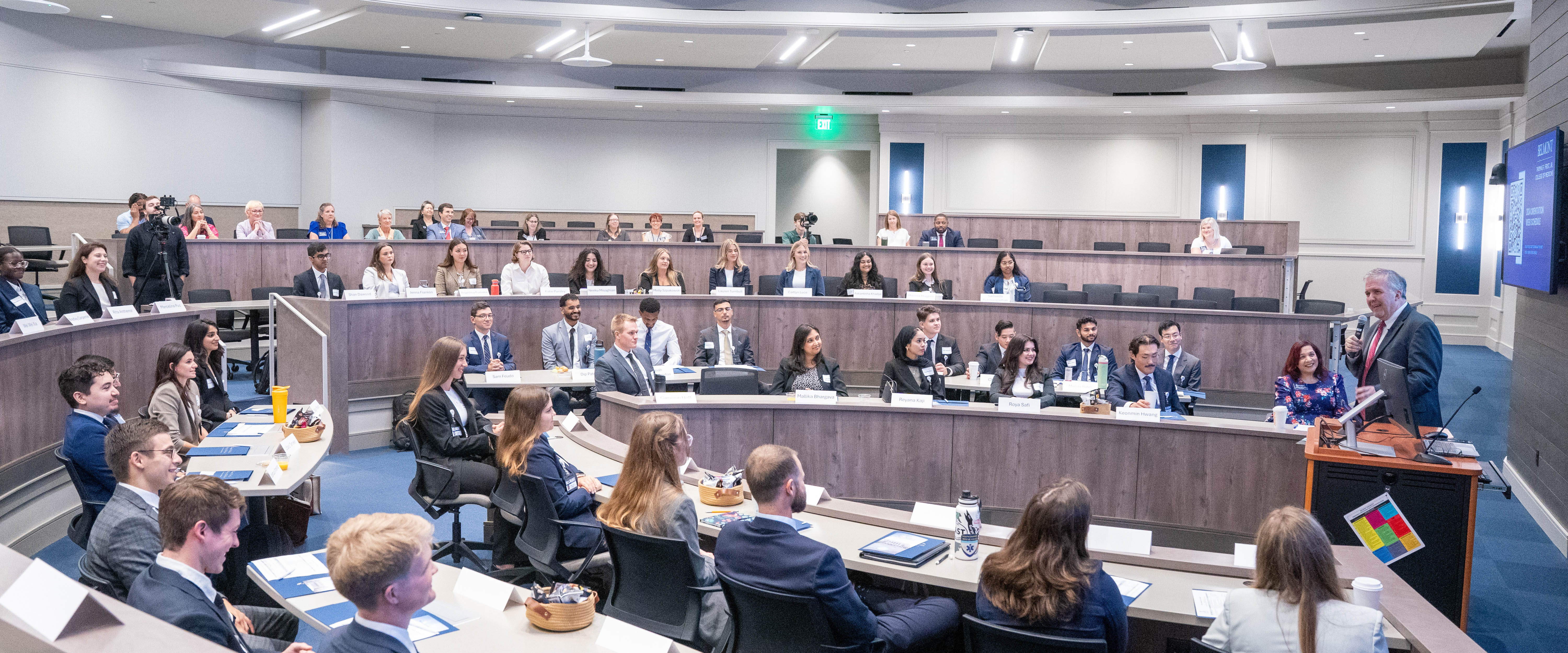 Students in an auditorium type classroom during medical school orientation