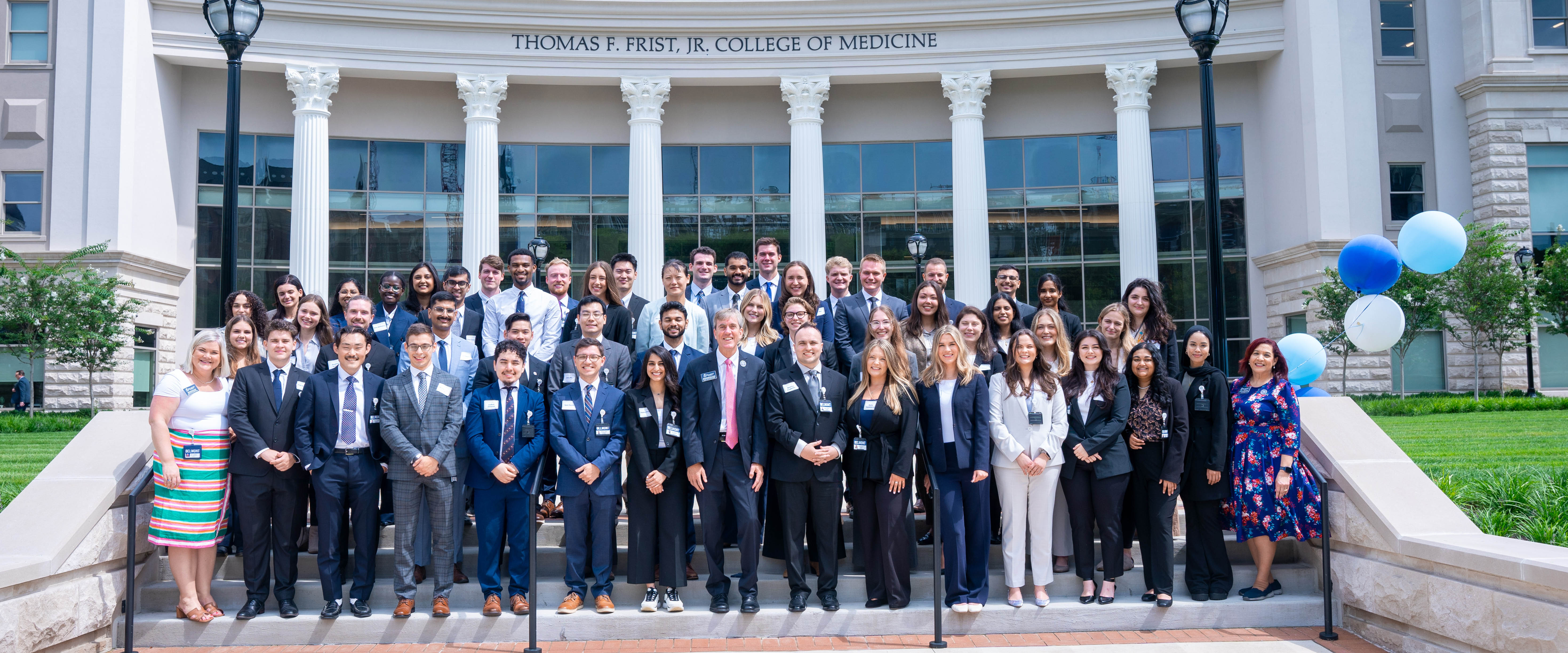 College of medicine students in front of the medical school building taking group photo