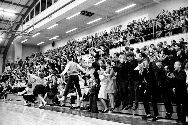Belmont students and players cheer on the basketball team during a game in the 1960s.