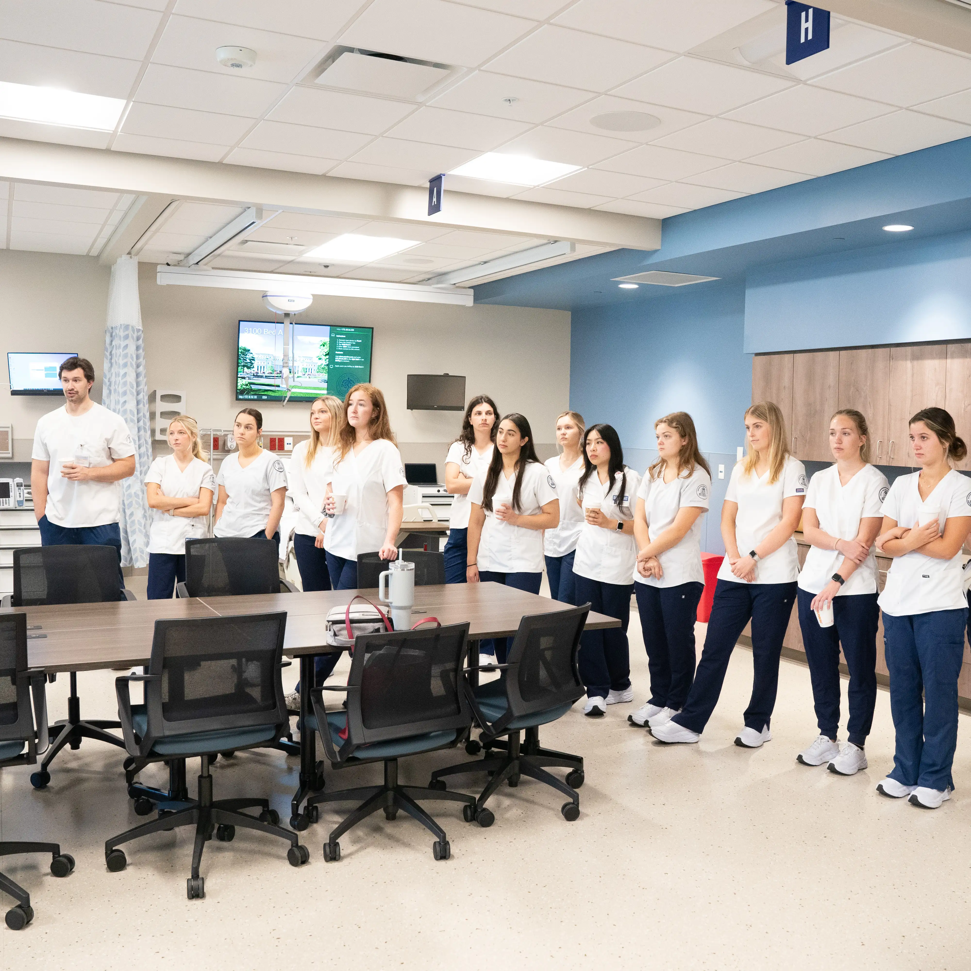 Nursing students gather for instruction in a collaborative classroom at Belmont University’s nursing simulation facility.