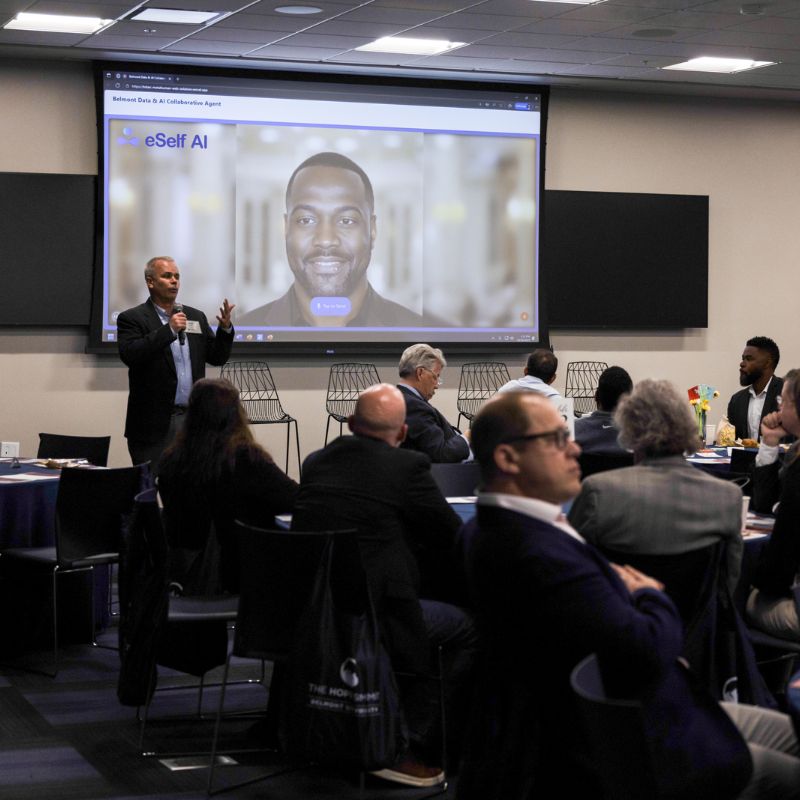 Man presenting to a room of people
