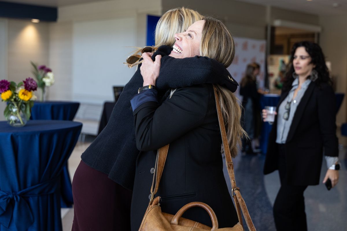 Two women hug at Hope Summit